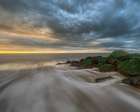 USA, New Jersey, Cape May National Seashore. Stormy sunrise on ocean shore. Art Print